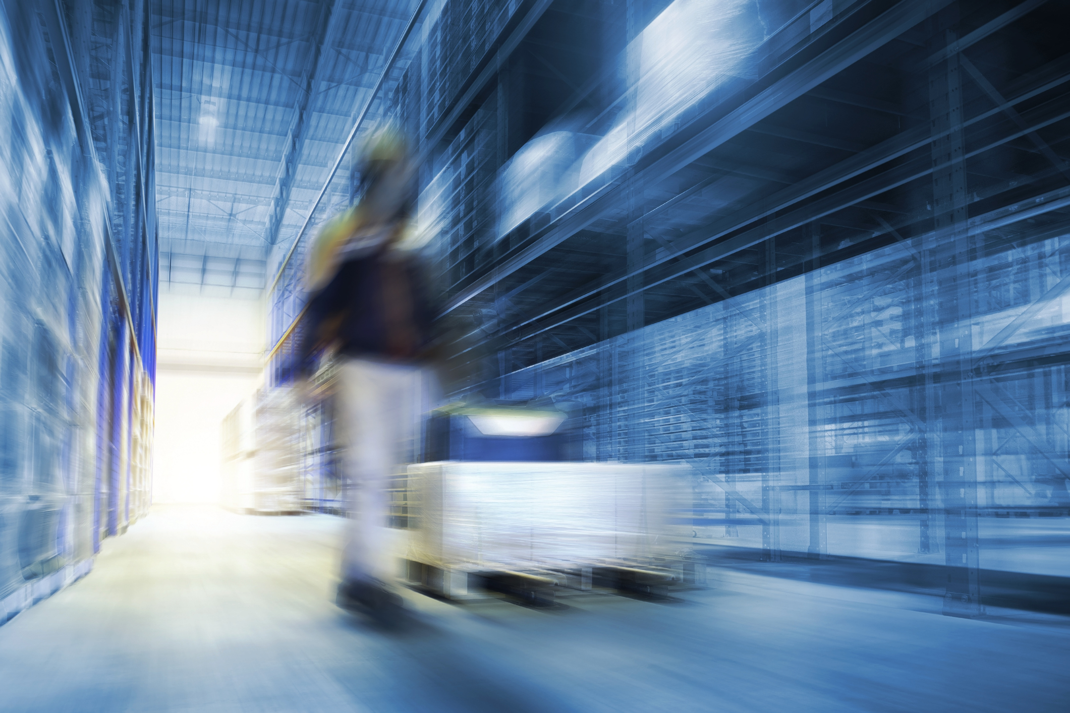 Blurred Warehouse For Industrial or Logistics Background. Interior Warehouse Space Storage of Tall Shelf. Business Distribution Storage Cargo.